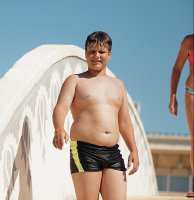 Proud chubby boy enjoying summer